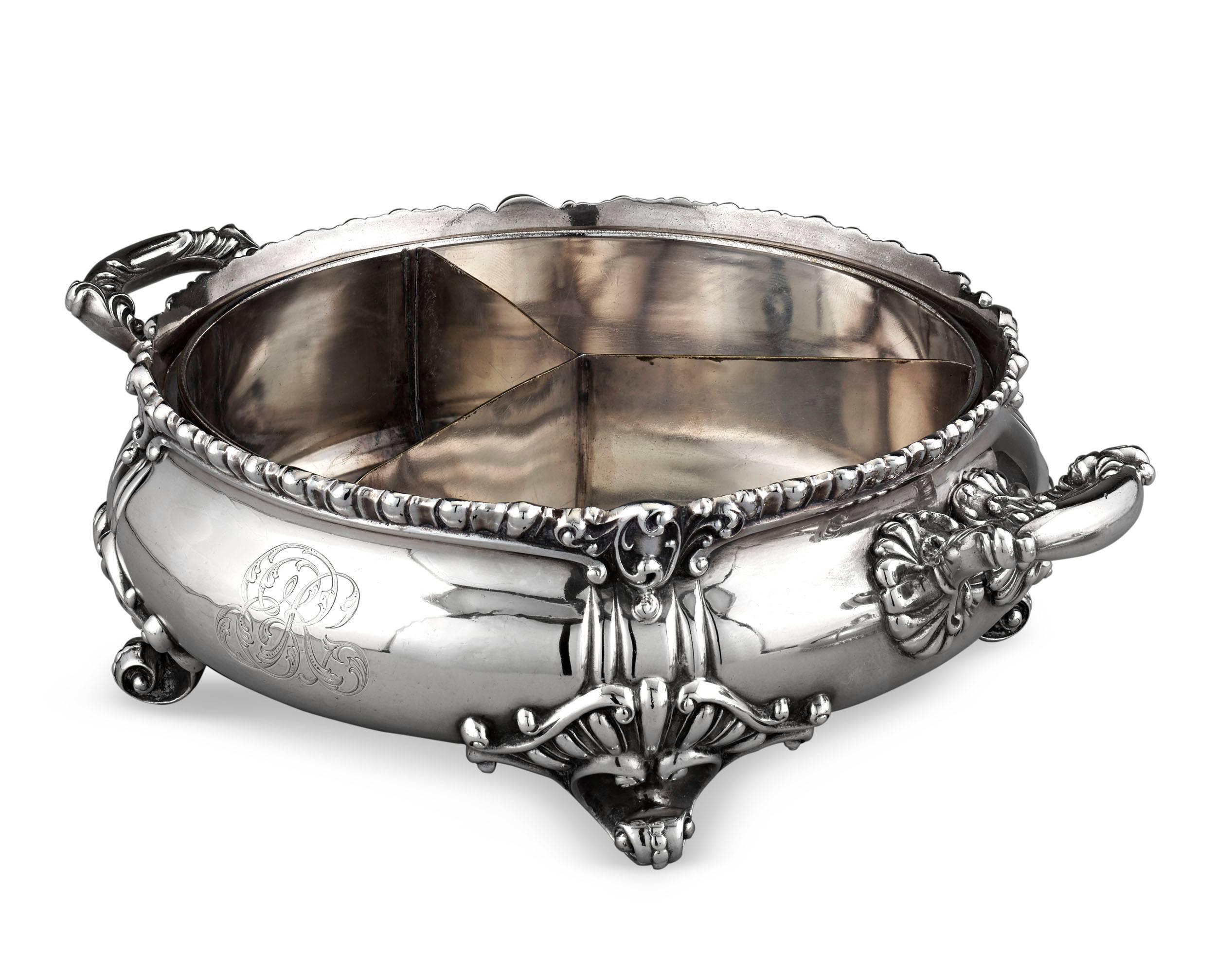 This beautiful silver covered serving dish was crafted by the American silversmithing firm of Theodore B. Starr of New York. Set upon scrolling feet with grand gadroon detailing, this wonderful dish features the variety of robust, Baroque-inspired