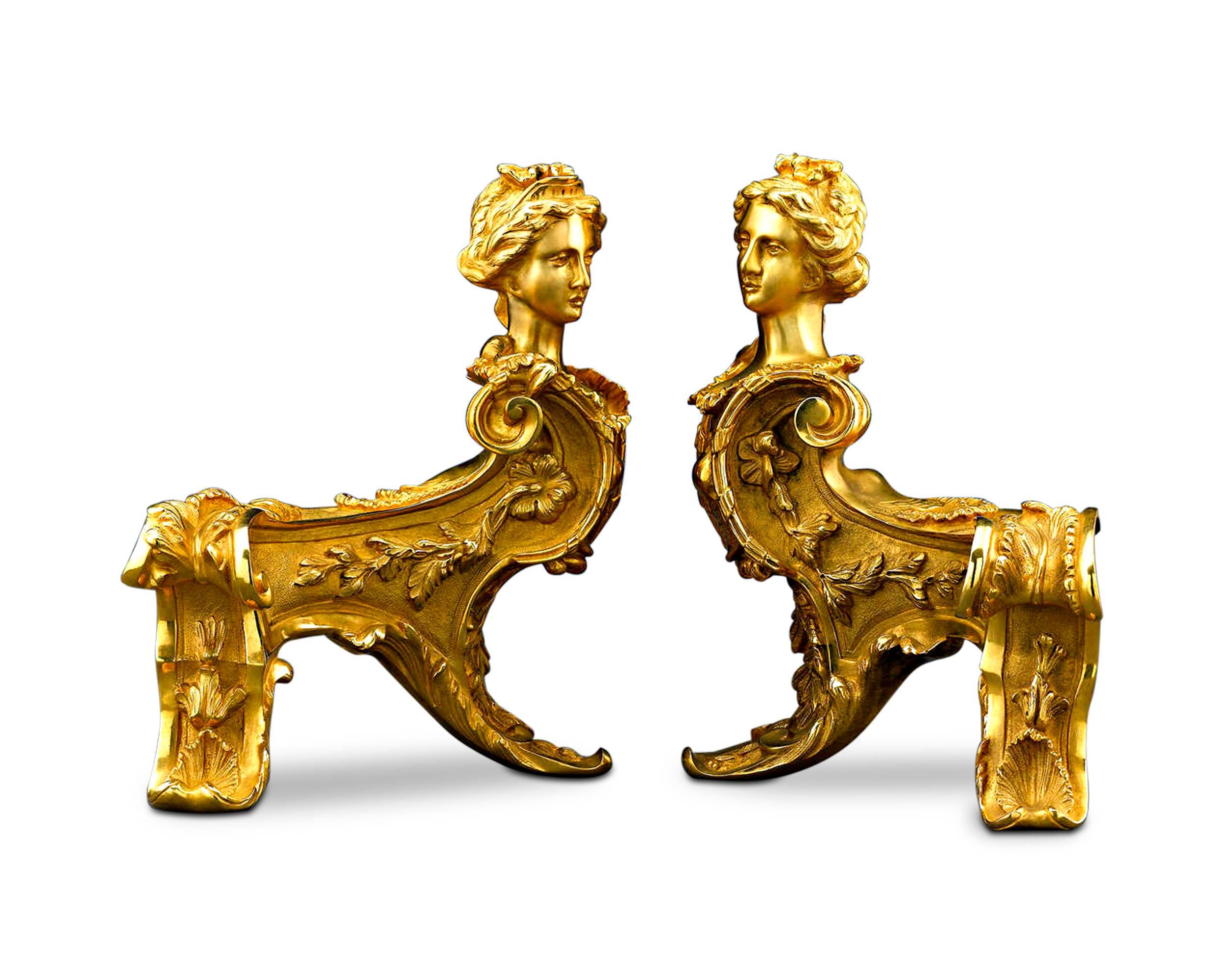 This rare and ornate pair of bronze ormolu chenets, or andirons, takes the form of two majestic sphinxes. Crafted in a thrilling Louis XIV style, these bronze ormolu fireplace guards also exhibit Classic Rococo decoration, such as flowering