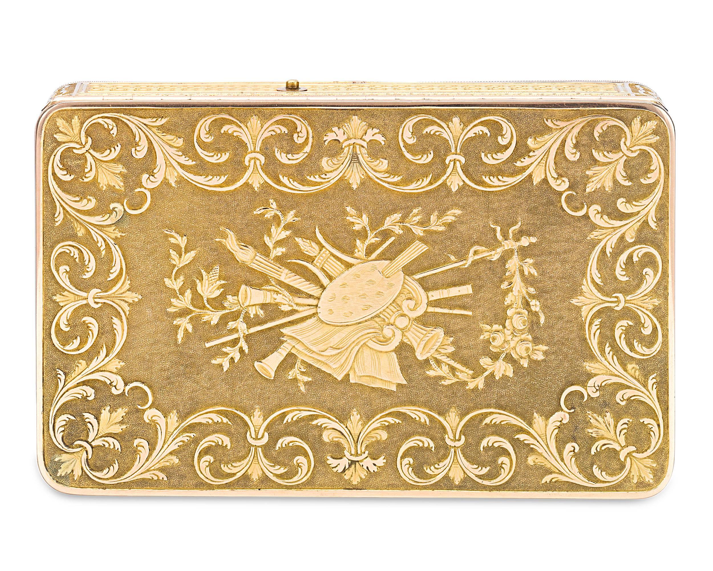 This special and important Swiss gold music box is chased and engraved with a set of musical instruments surrounded by elaborate swirls of ornate foliage. Embossed with a delightful braided gold design, the two-compartment box features an exquisite