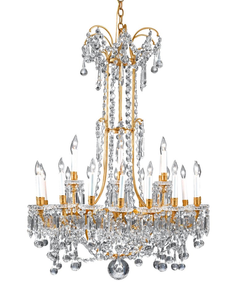 This Baccarat crystal and doré bronze chandelier of monumental size and opulent design is truly a splendid sight to behold. Boasting 24 lights, this incredible and captivating design is distinguished by the oversized drops of hand wood-polished
