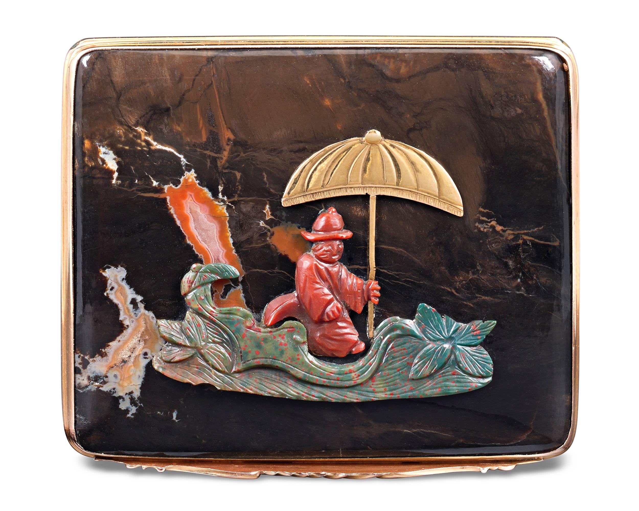 A marvelously carved chinoiserie motif adorns the lid of this incredible 19th-century French tabatière or snuff box. The charming scene is intricately crafted in the form of a boating figure who holds aloft an umbrella formed of yellow gold, while