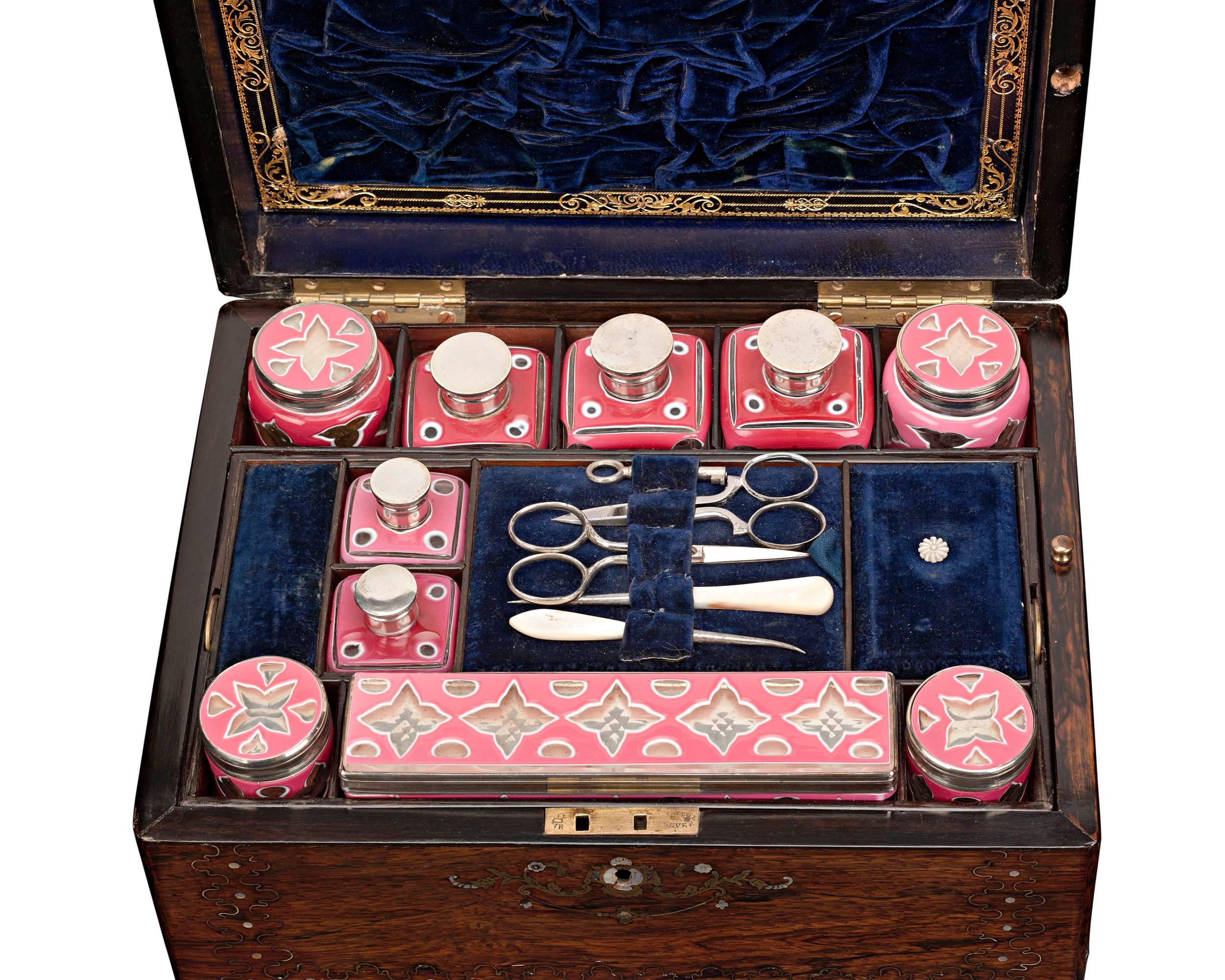 A work of extraordinary craftsmanship, this exquisite English vanity case is as much an item of luxury as it is of necessity. Known as a nécessaire de voyage, the case features a luxurious blue velvet-lined interior that houses various toiletry