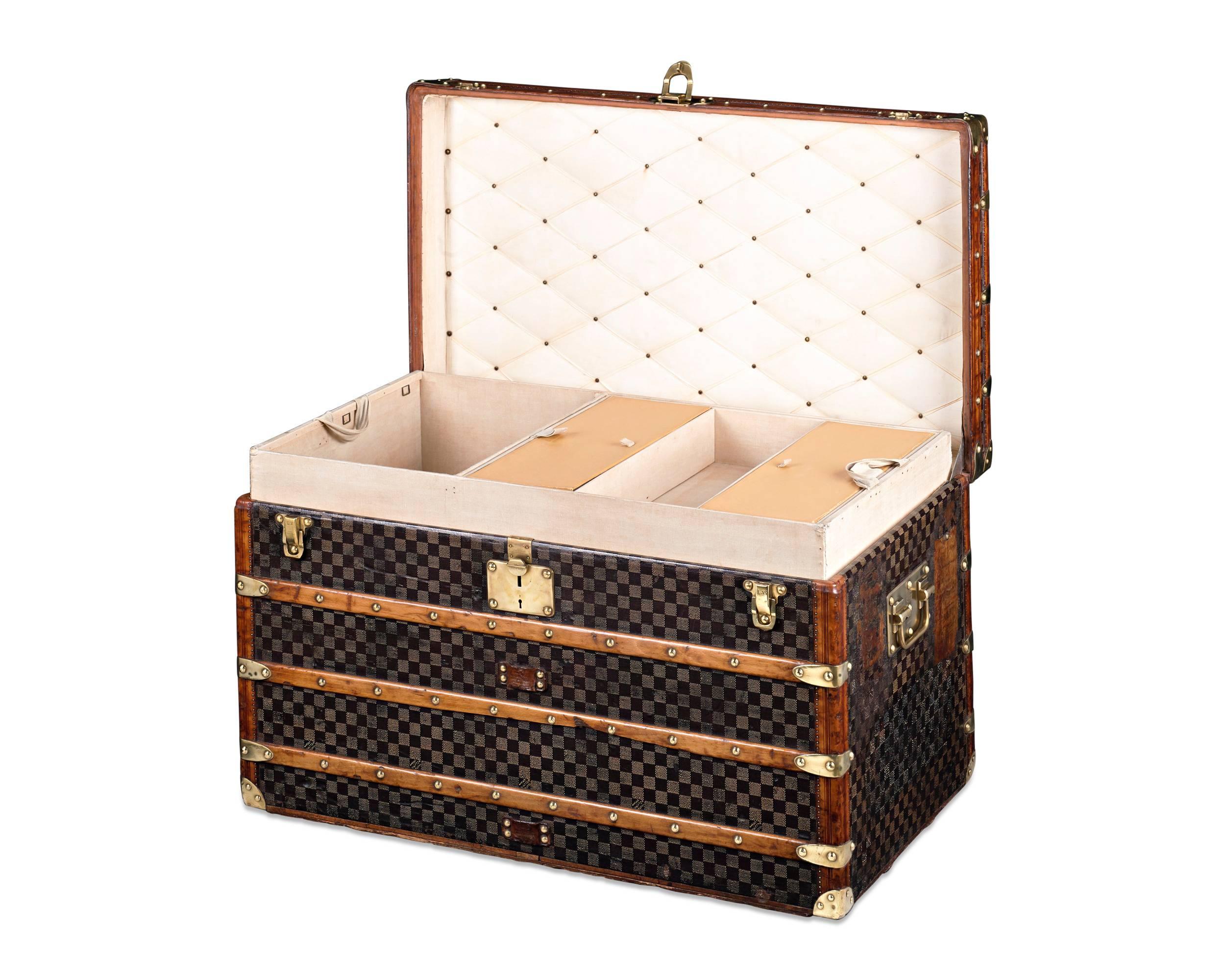 This sophisticated Louis Vuitton steamer trunk evokes the glamour of turn-of-the-century travel. Adorned with Vuitton’s distinctive checked Damier pattern on its canvas covering, this trunk is both elegant and well-crafted, with original brass