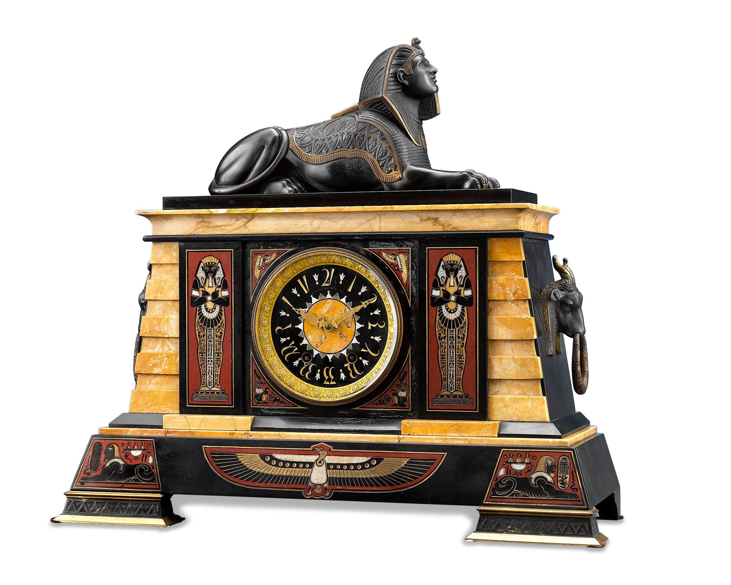 This Egyptian Revival clock garniture by J. E. Caldwell & Co. of Philadelphia is almost identical to the set that is housed in the collection of the Metropolitan Museum of Art. Composed of a clock and two obelisks, this garniture is crafted of