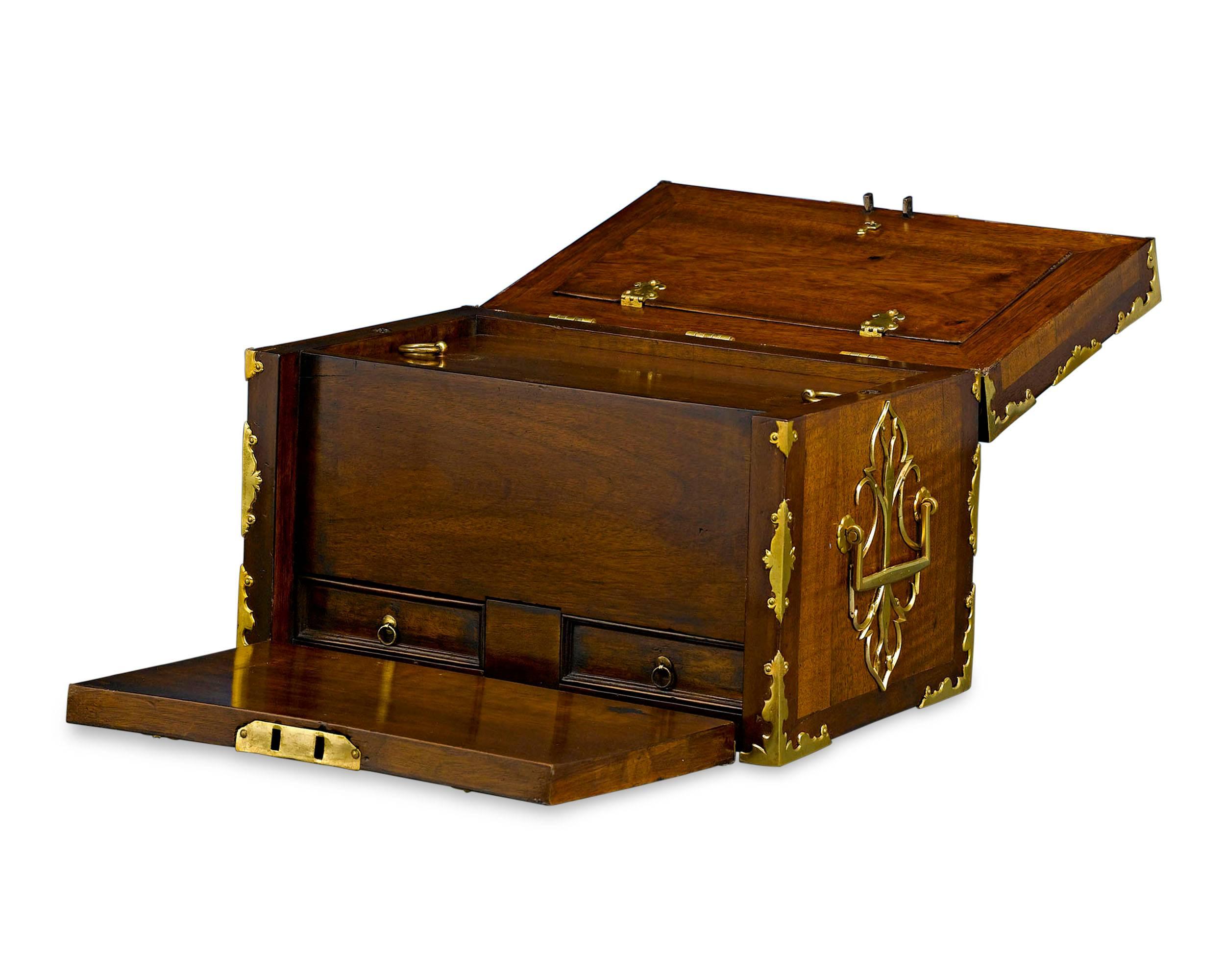 An important relic that is as versatile as it is beautiful, this English lock box boasts exceptional quality and condition for its age. Also known as a ship’s chest, a sturdy lock box such as this would have protected one's valuables on a ship and
