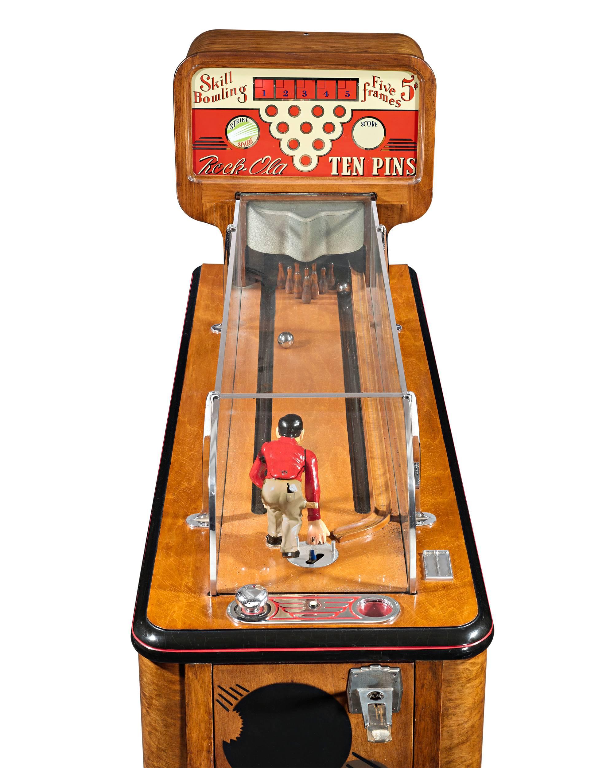 This exceptionally rare vintage ten pins machine was among the most popular arcade games ever produced by the Rock-Ola Manufacturing Corporation. Known as a “mannequin” model, this machine allows a customer to control the miniature molded figure