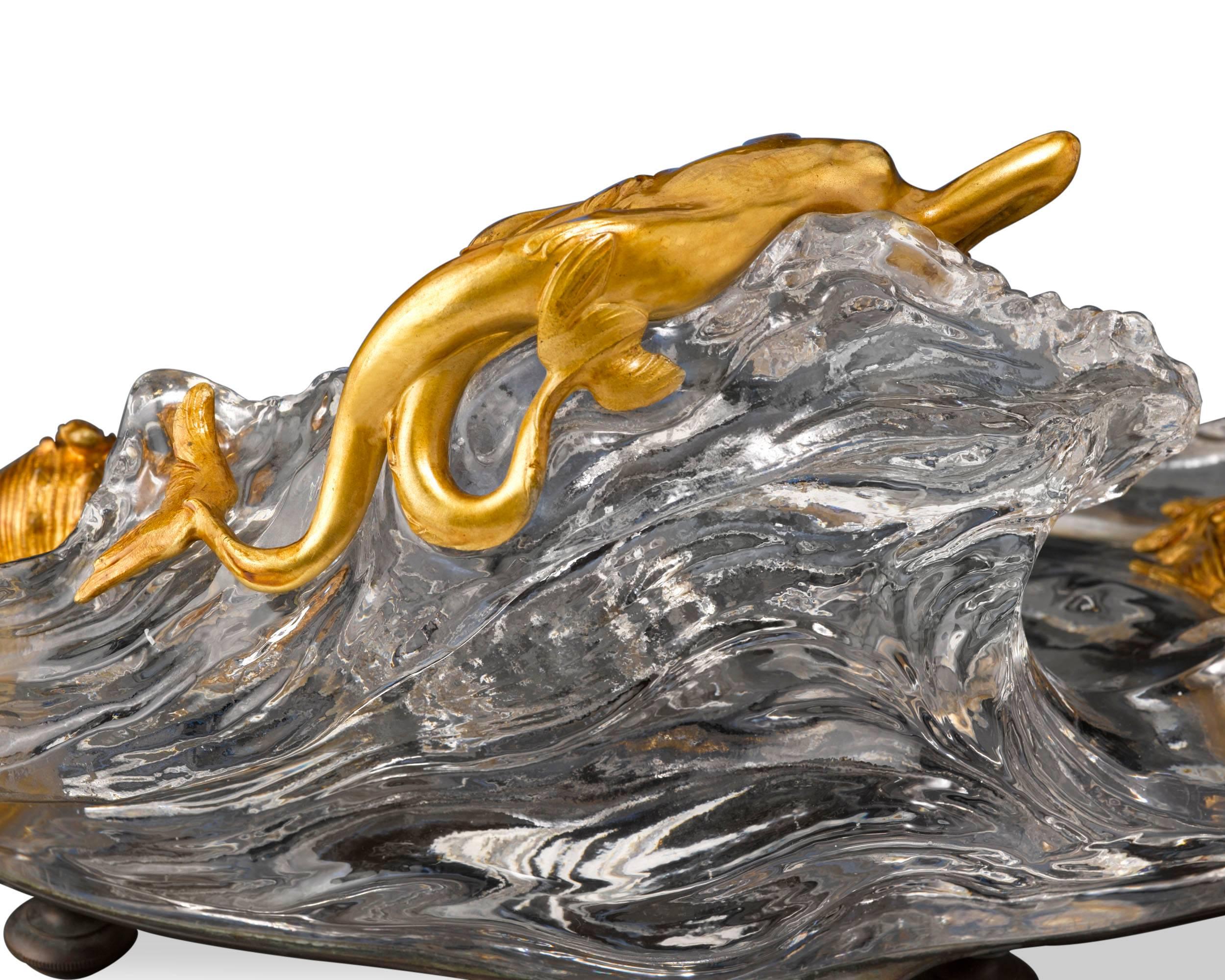 This extraordinary crystal inkwell from the renowned Baccarat is a piece of exquisite charm and grace. Featuring a doré bronze mermaid languishing upon the crest of a rolling wave, it effortlessly embodies the organic movement so treasured by Art