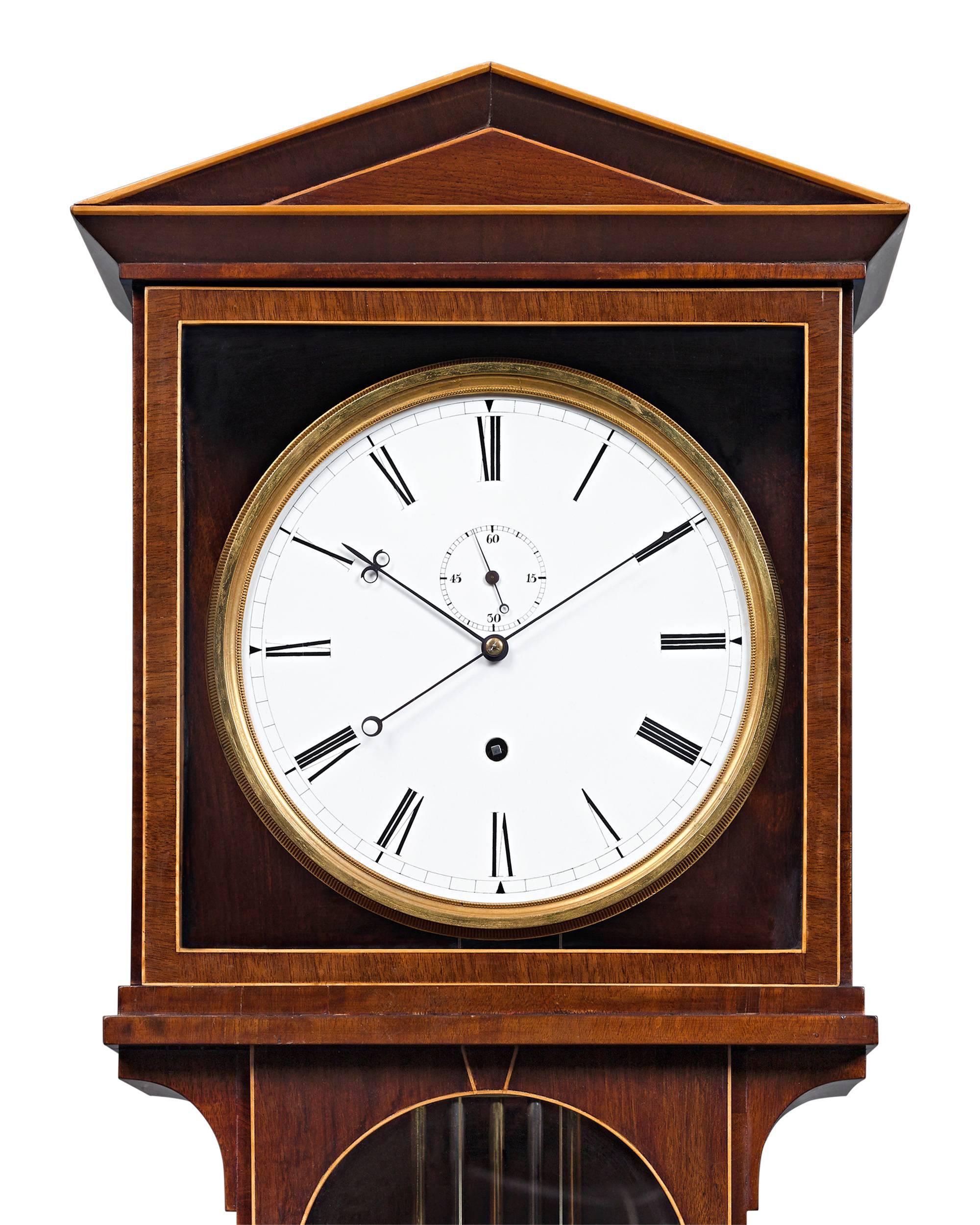 This rare Vienna regulator clock, or Laterndluhr, beautifully demonstrates the precision and superiority of Viennese craftsmanship. The elegant Empire style case, crafted from the finest mahogany with delicate maple inlay, houses a weight driven
