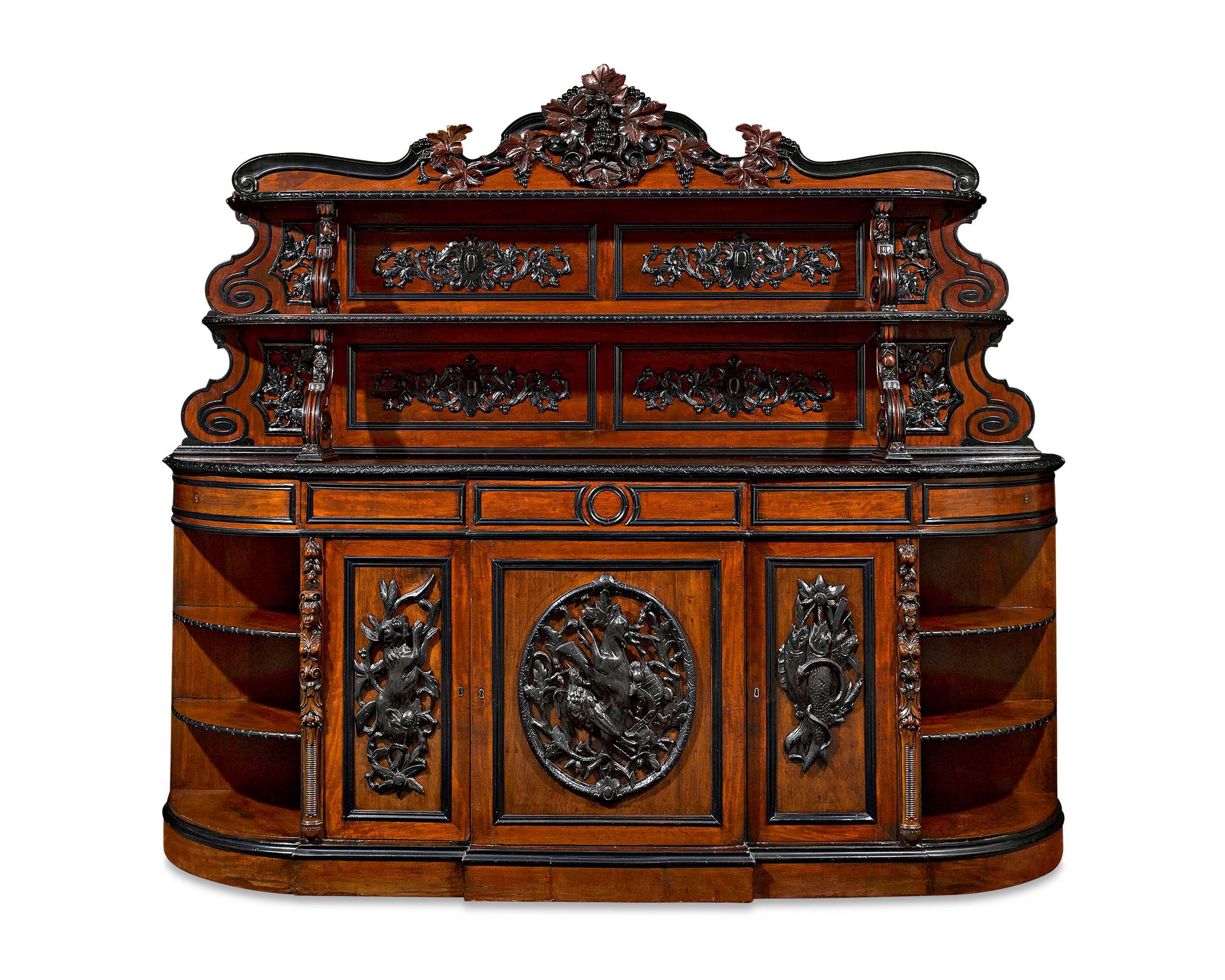 This magnificent French sideboard is a work of both massive size and extraordinary craftsmanship. Carved entirely from luxurious mahogany, the bold piece of furniture reaches a width of over 8 feet and a height of over 7 feet and displays all of the