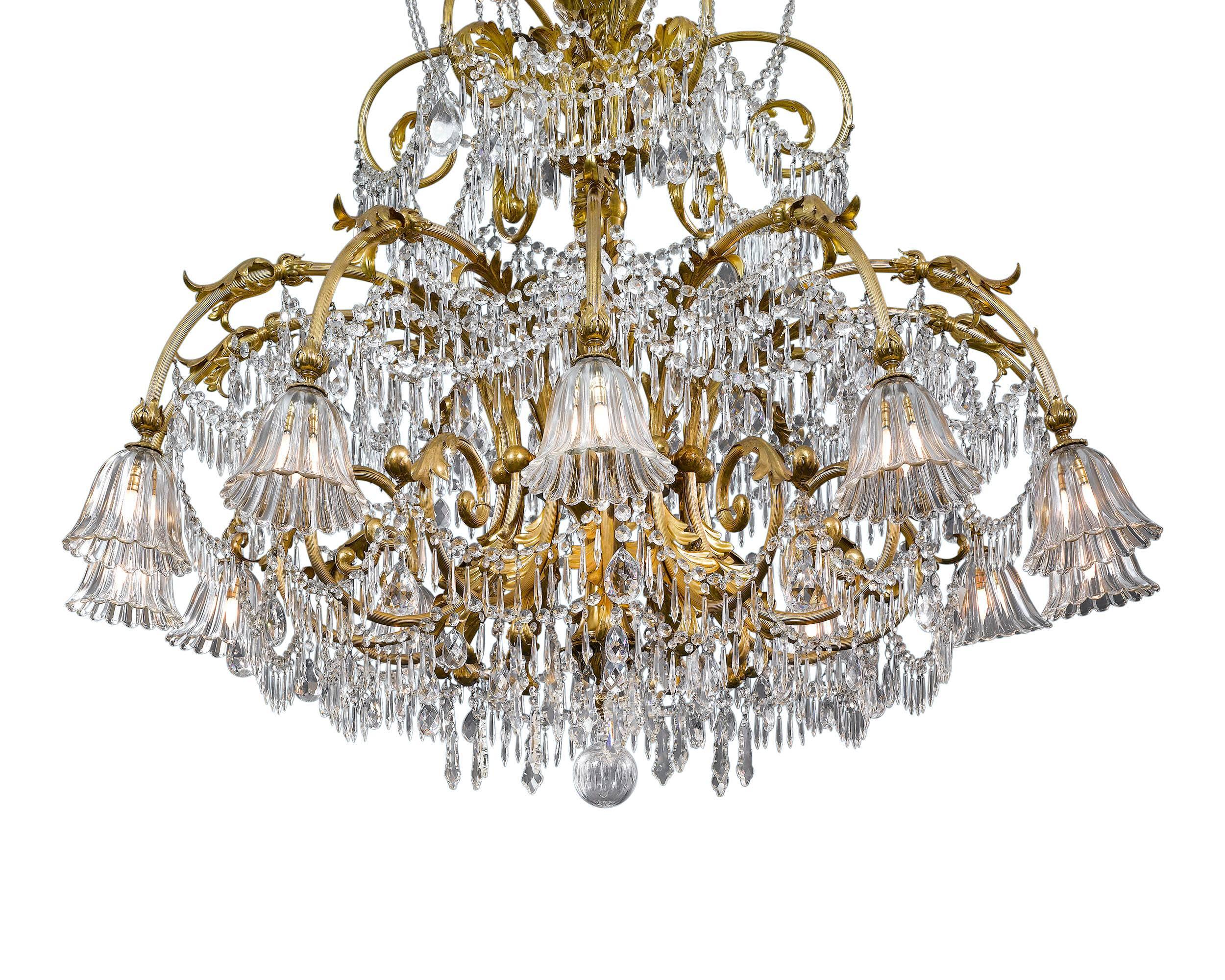An extraordinary and monumentally-sized Art Deco period chandelier beautifully designed with dazzling Baccarat crystal hanging from scrolling brass branches. This incredible eighteen-light fixture is of exceptional quality and size, boasting some of