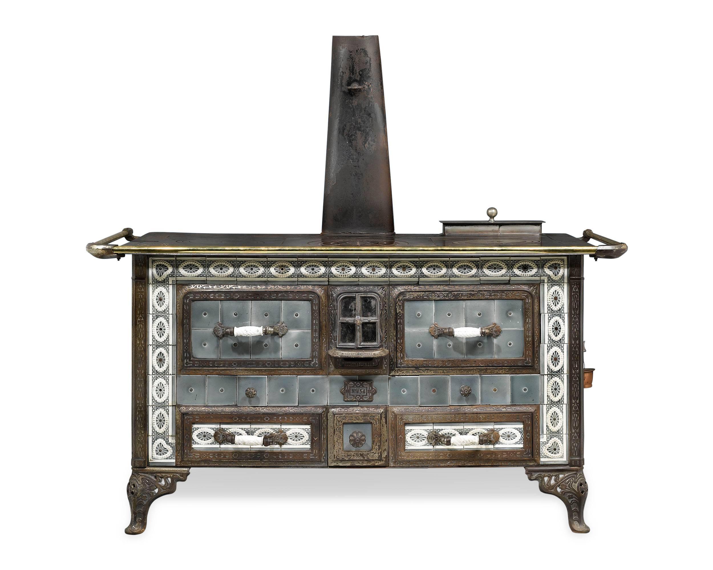 This extremely rare and striking Sougland-Aisne stored heat cooker is a work of outstanding design. This Art Nouveau-period cast iron stove could either be fired with charcoal or wood, and has three “burners” on top with covers and concentric