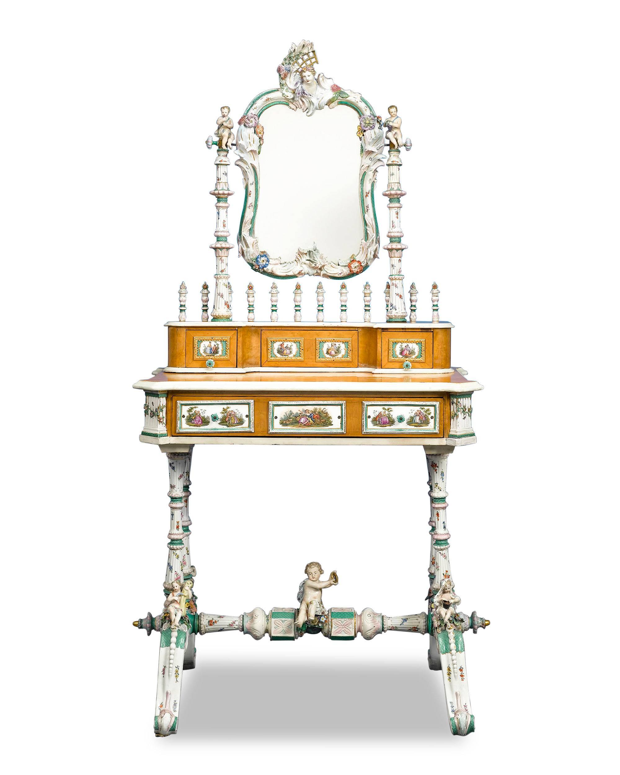 This lavish bird's-eye maple dressing table is a work of astounding artistry and rarity. The piece is elaborately embellished with exquisite Meissen Porcelain throughout. Exquisitely hand-painted with gilt accents, the cartouche-form mirror frame is