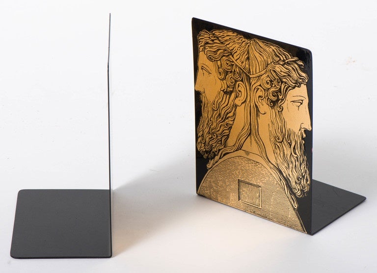 A pair of Janus bookends by Piero Fornasetti.
Depicting Grecian reverse classical heads.
Enamelled metal, lithographically printed.
Label to base,
Italy, circa 1960.
Dimensions: 20cm high x 15cm wide x 10 cm deep.