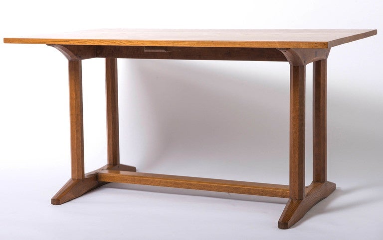 An early Gordon Russell oak trestle refectory table.
Of rectangular form on double octagonal supports sitting on chamfered edge supports, with chamfered stretcher.
Remains of paper label dates the table to 10/9/27.
Design No. 318.
England
