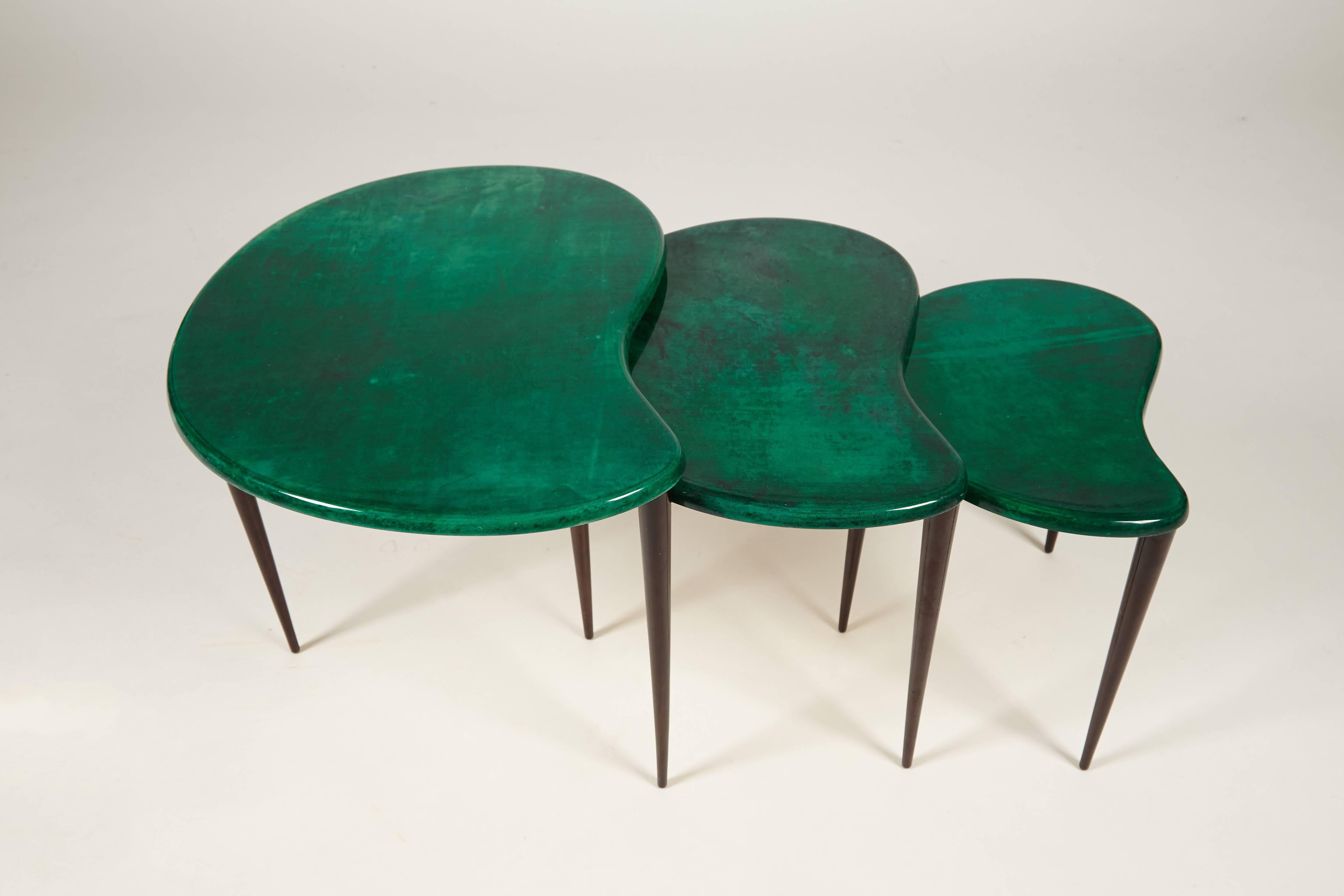 You are viewing a stunning set of three nesting tables by the great designer, Aldo Tura, Italy. The tables are from the early to mid-1960s and covered in a green dyed parchment and lacquered technic. A true signature of an Aldo Tura design.