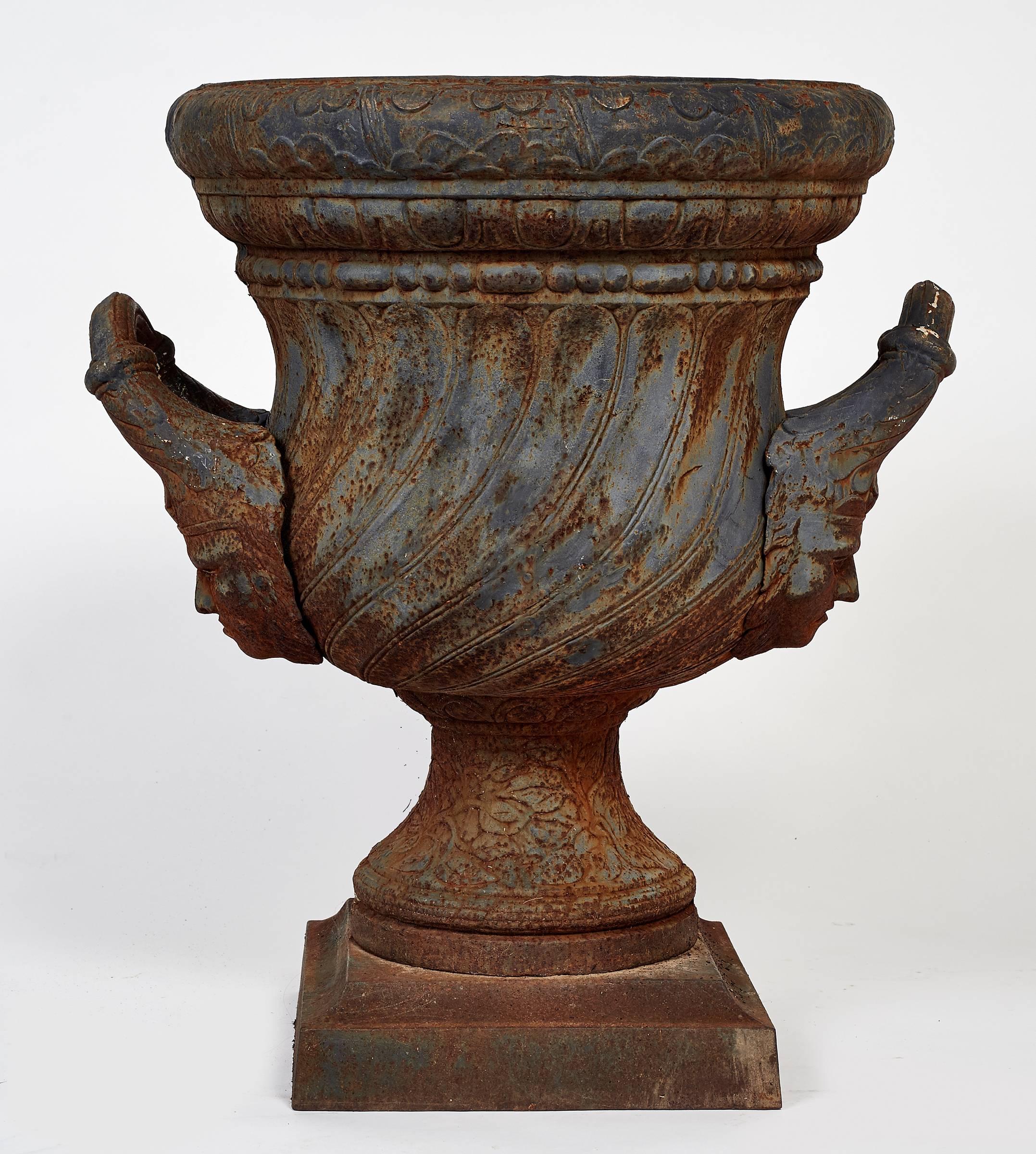 You are viewing a striking pair of Indian faced Garden Urns. Acquired from a sprawling Connecticut estate. They are in fantastic condition with no dents. They have this wonderful patina that has age so well. Please take of the details in the faces
