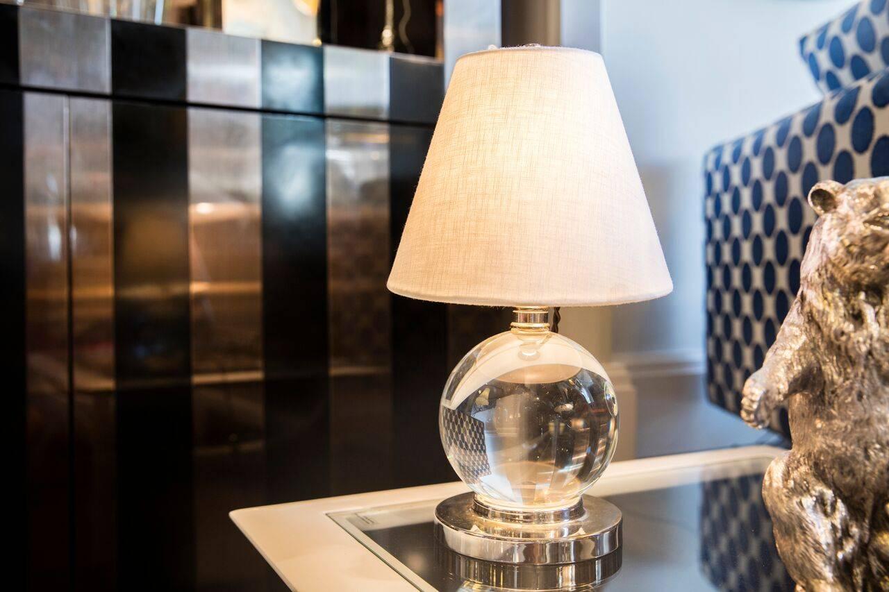 A wonderful pair of small crystal ball table lamps in the style of Jacques Adnet, circa 1940s.