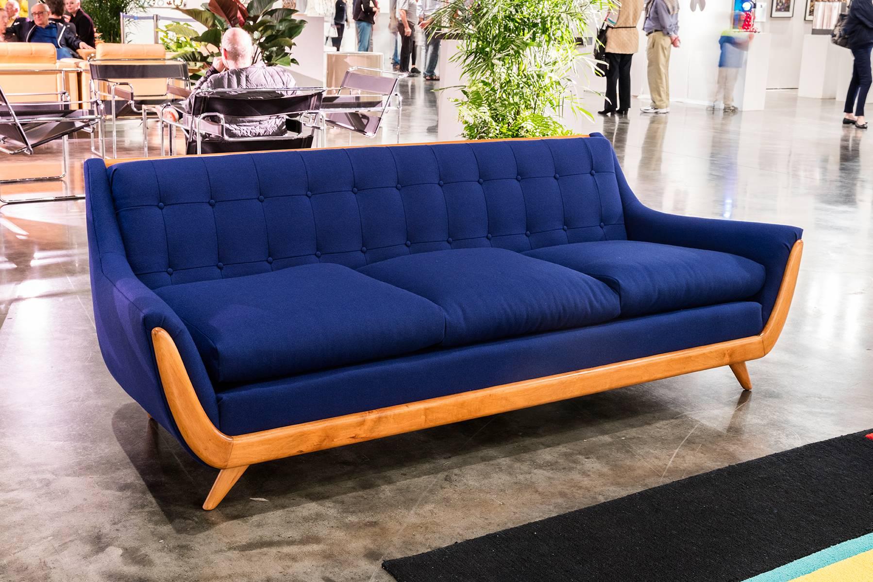 Beautiful reupholstered royal blue sofa with wood trim.