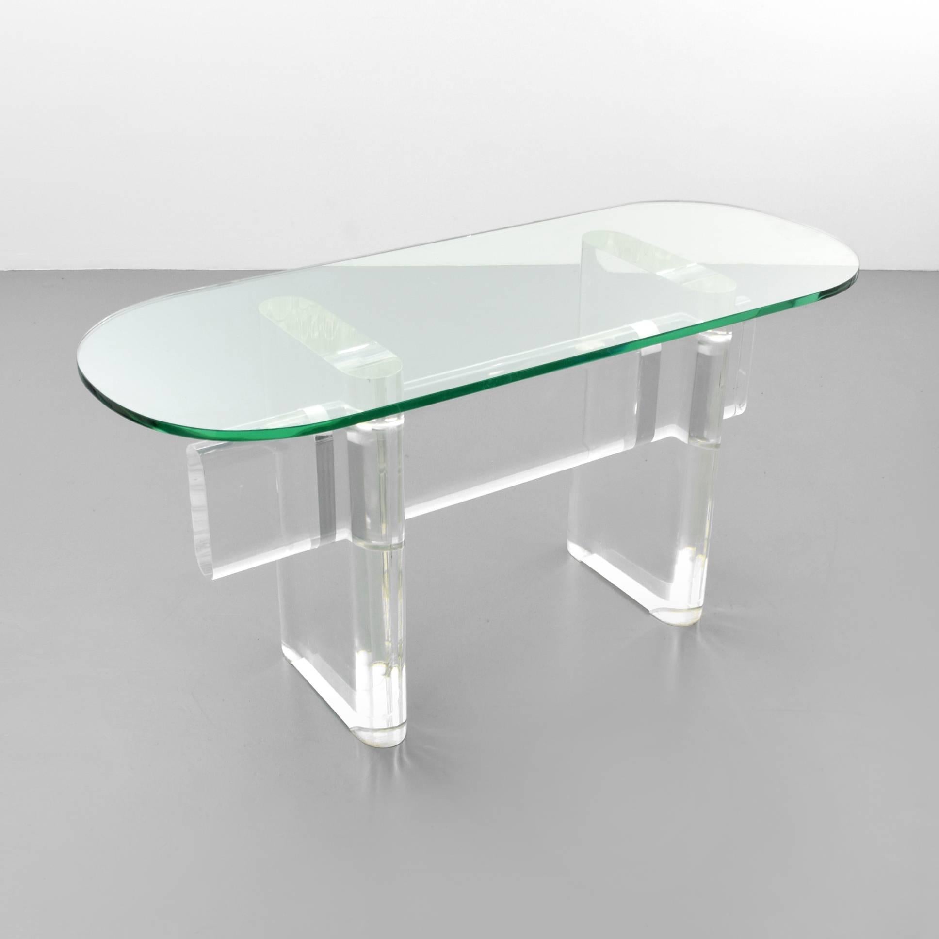 Karl Springer Mid-Century console table with pure lines and thick Lucite base with glass top. Signed Karl Springer.
