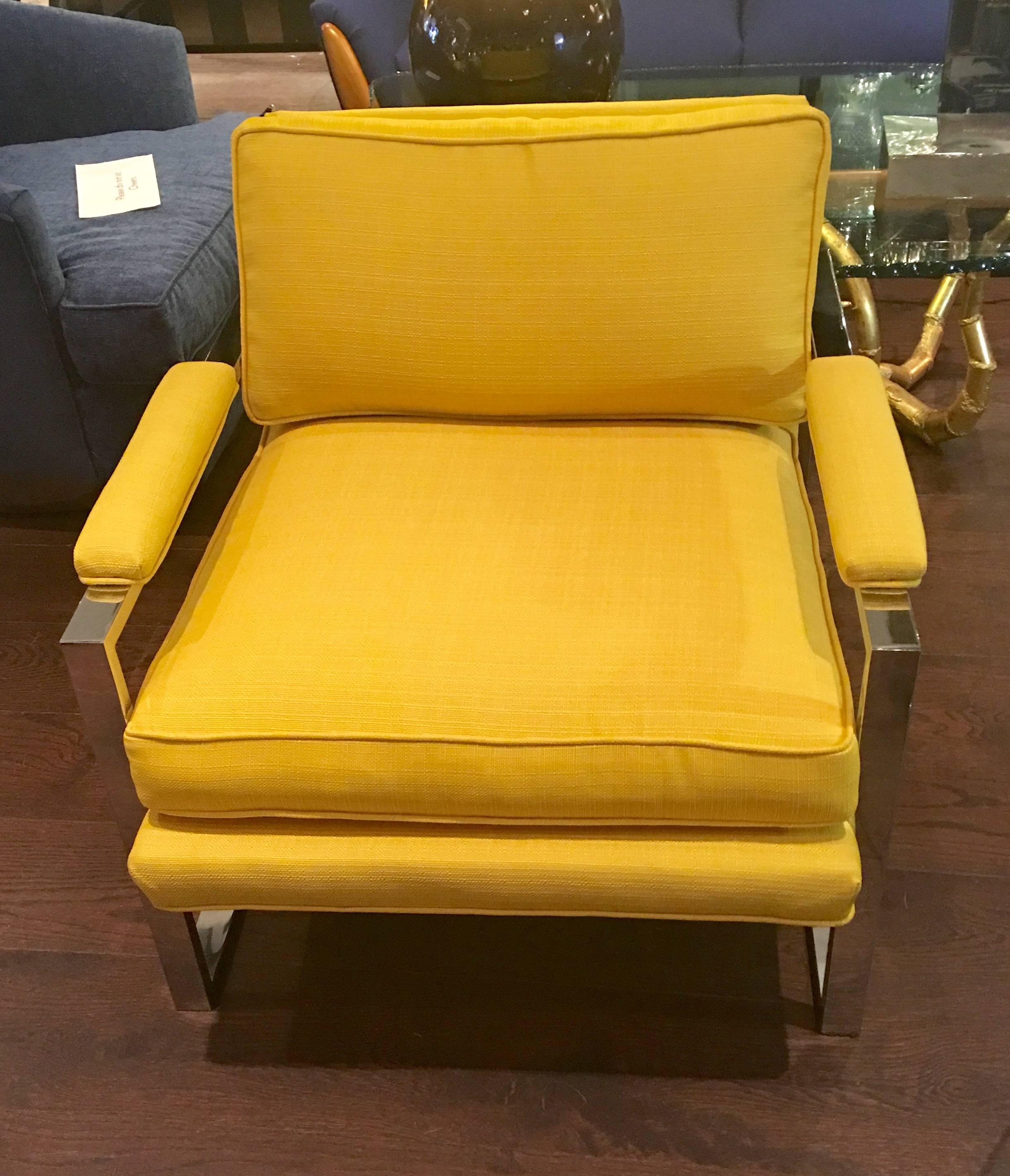 A pair of Mid-Century Modern lounge chairs designed by Milo Baughman. Chrome frame with vibrant yellow newly upholstered fabric.
