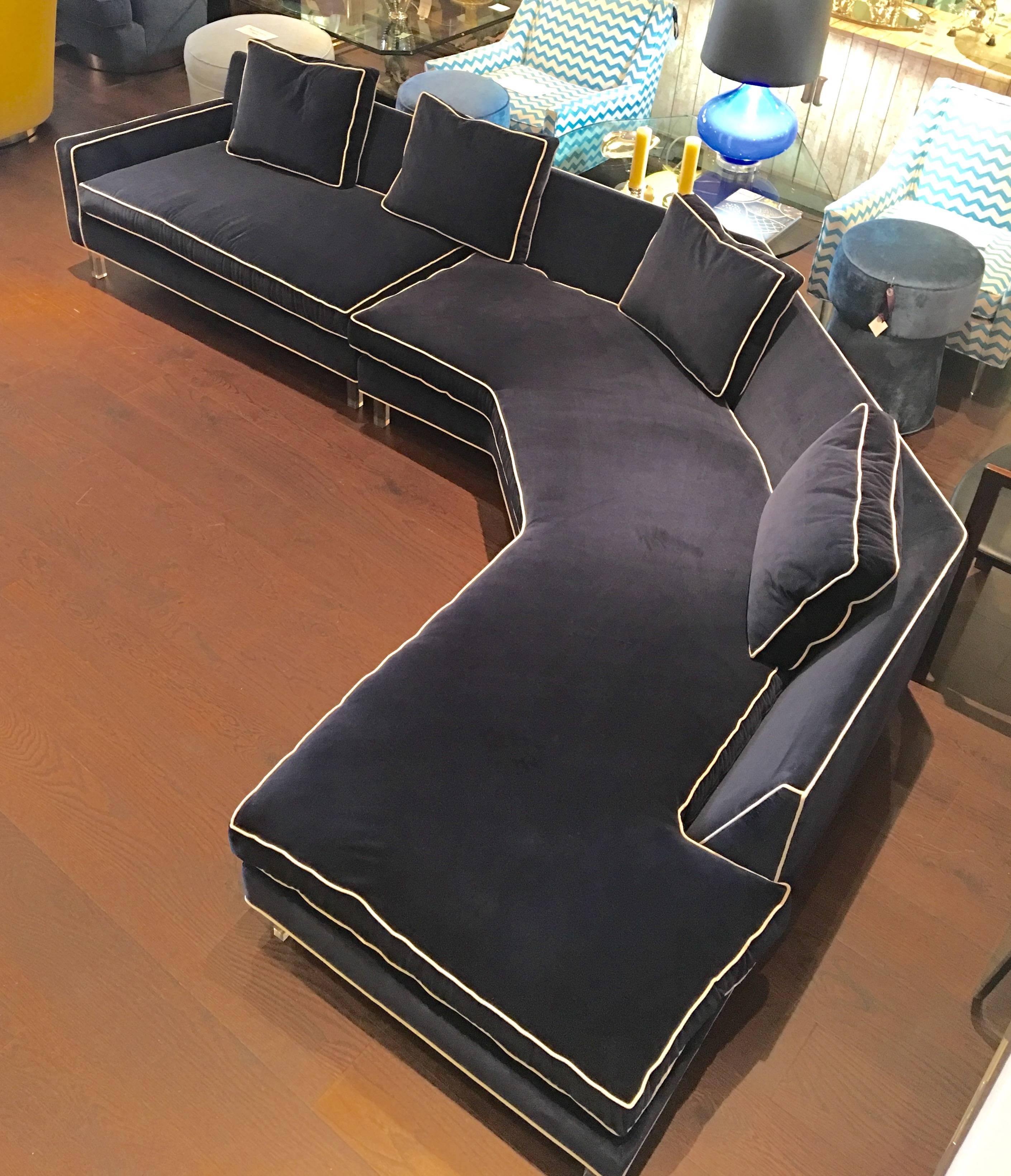 Very stylish two-piece sectional sofa newly upholstered in blue velvet fabric with white piping, circa 1970.