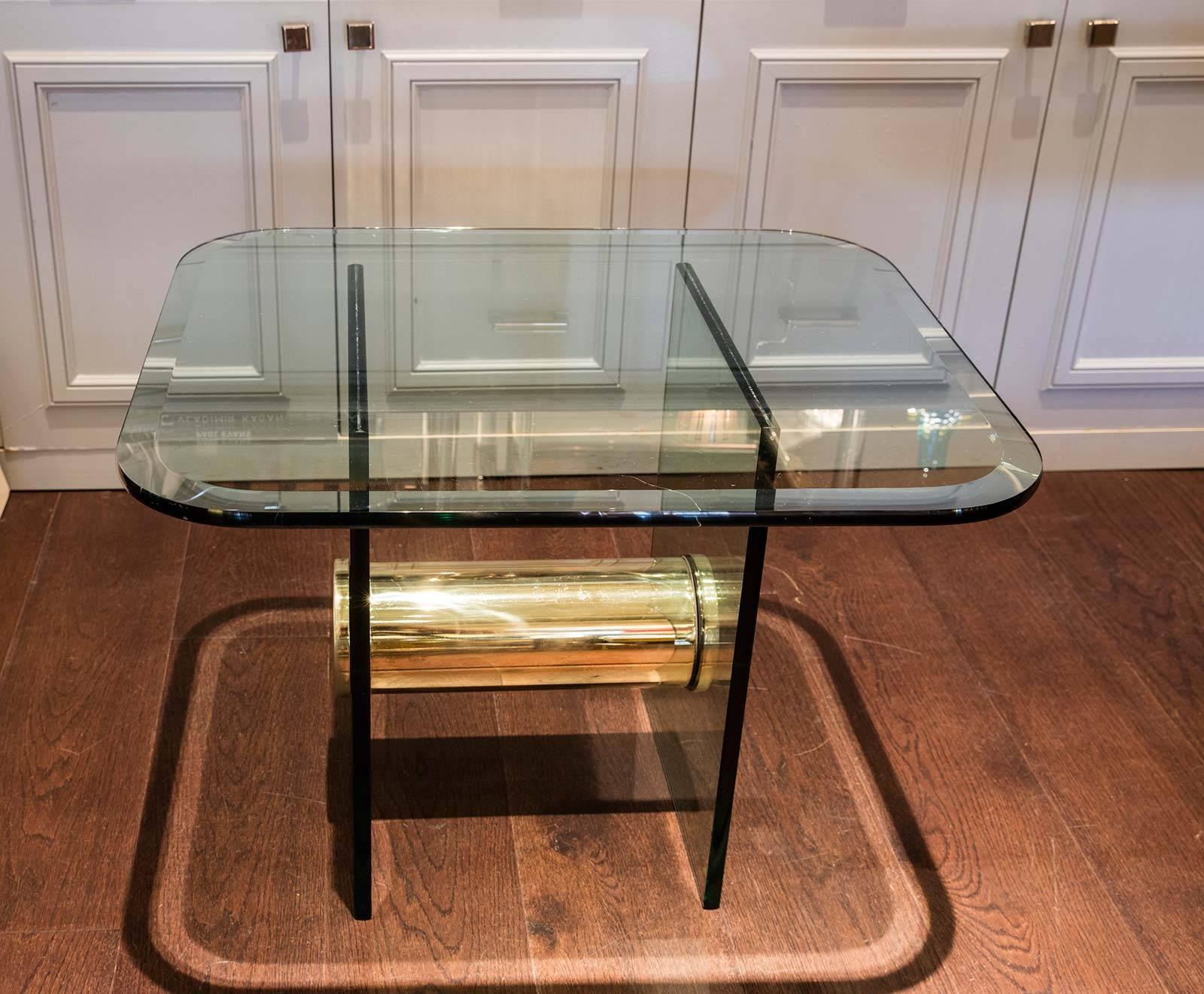 Devine glass end table with gilt metal drum in the style of Karl Springer, circa 1970.