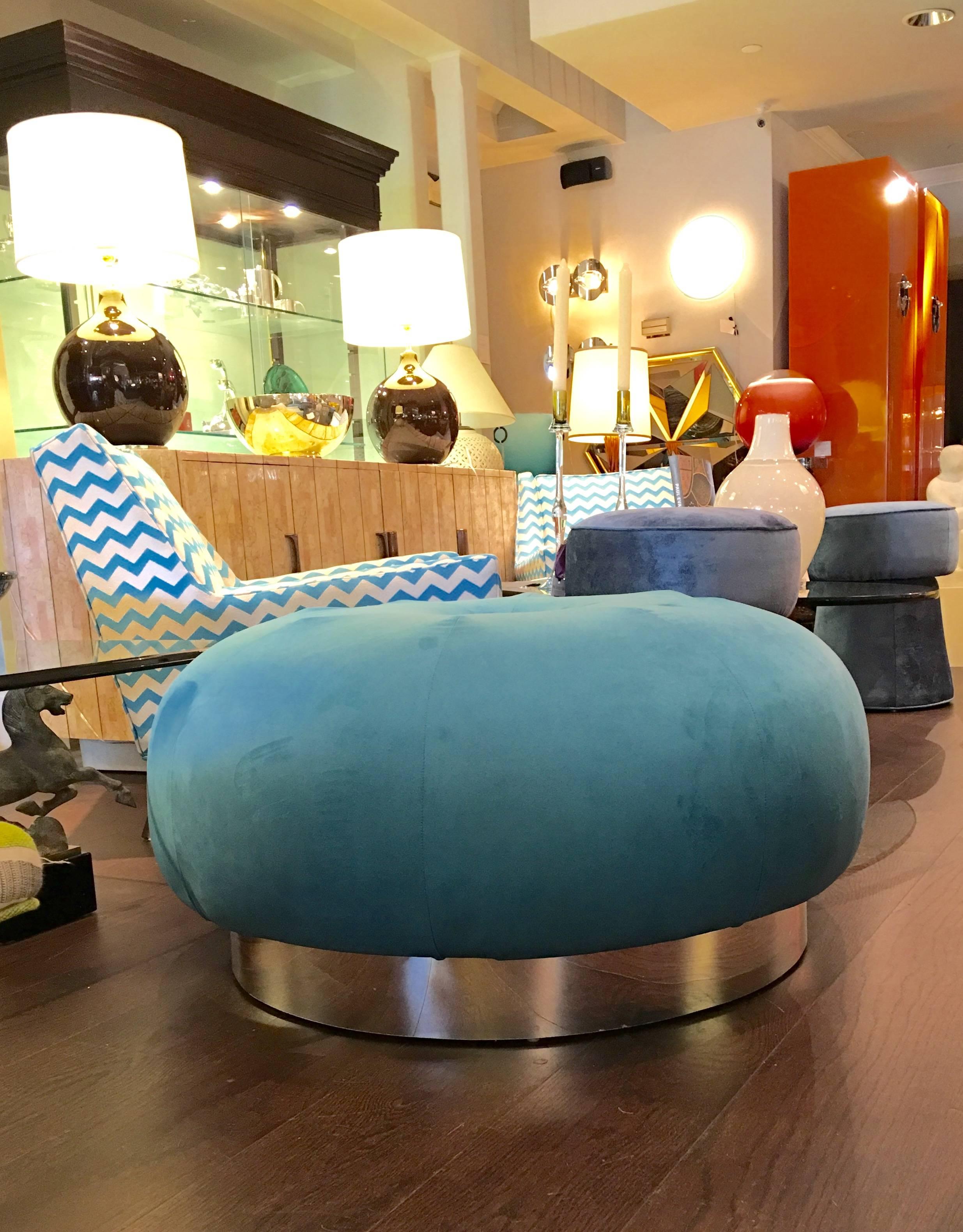 Oversized round pouf ottoman newly upholstered in a beautiful aqua blue fabric with chrome base, circa 1970.