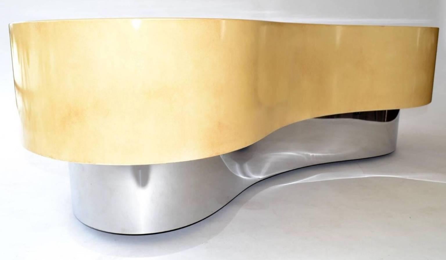 Kidney shaped biomorphic coffee or cocktail table in faux in the style of Karl Springer. Faux skin or parchment lacquered wood in neutral or earth tones on a mirror chromed metal base. Great organic design, USA, circa 1980s.