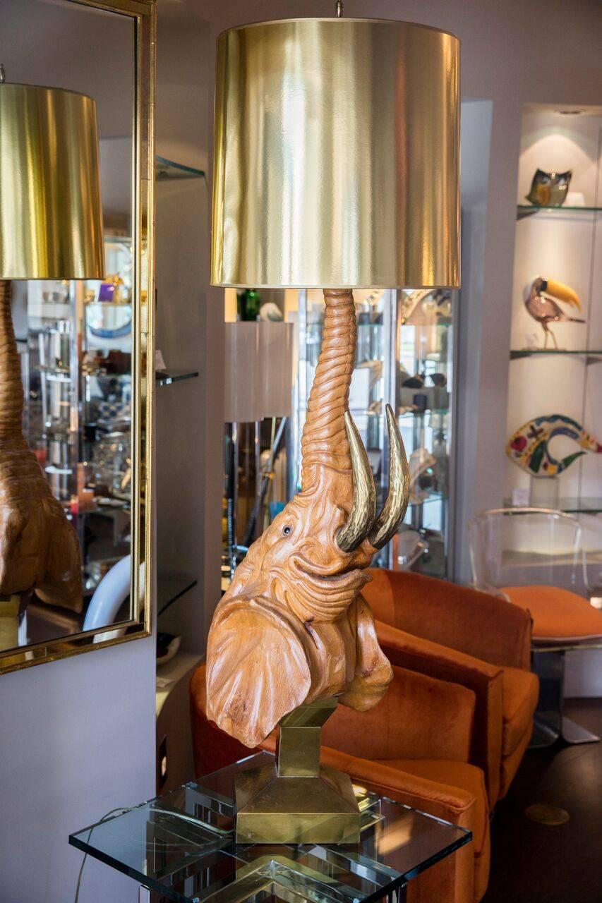 Beautiful sculptural table lamp in the shape of an elephant bust, sitting on a gilded metal base, circa 1970s.