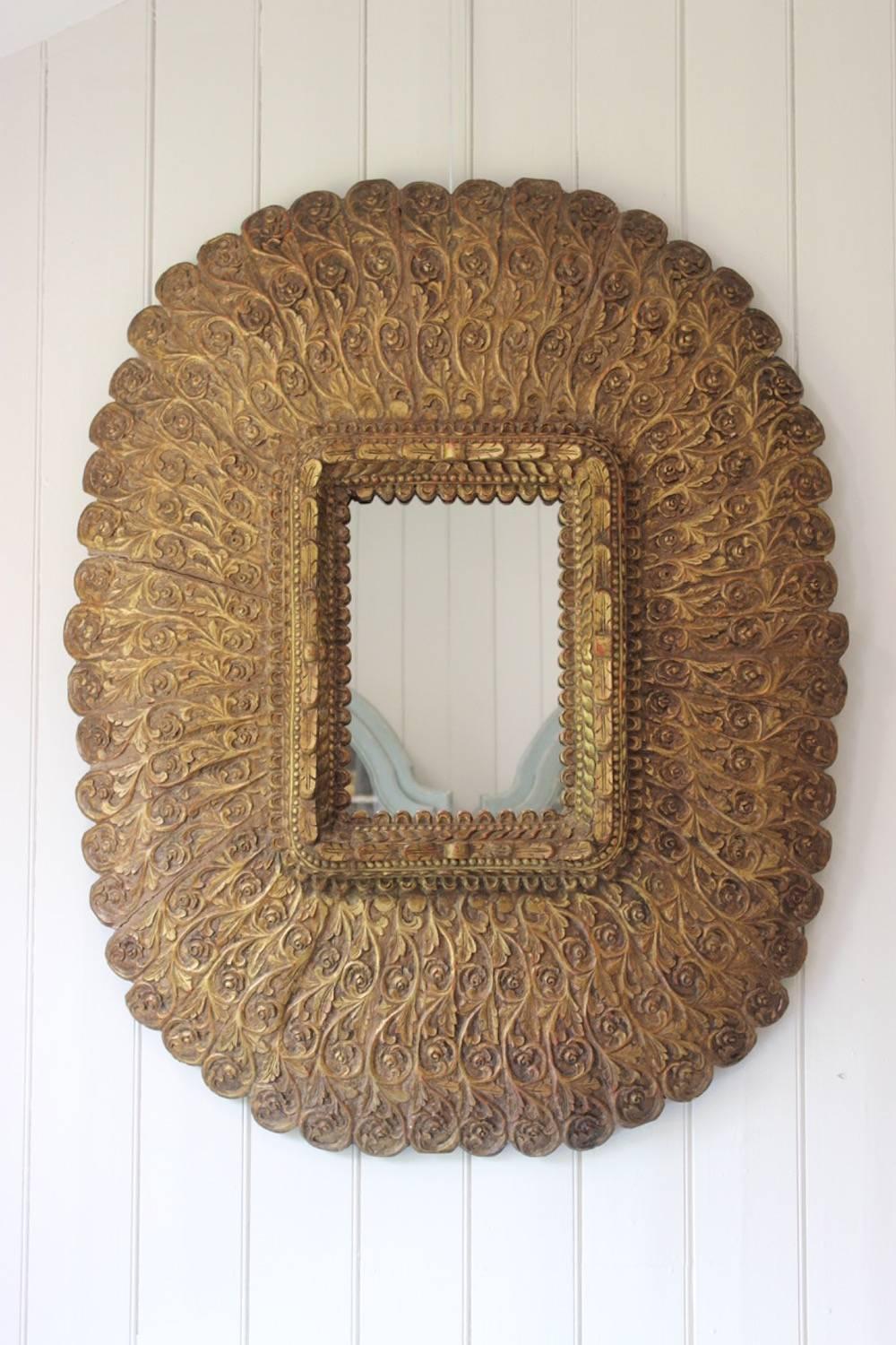 A spectacularly decorative and large, elaborately carved giltwood mirror, Spanish, circa 1960s.