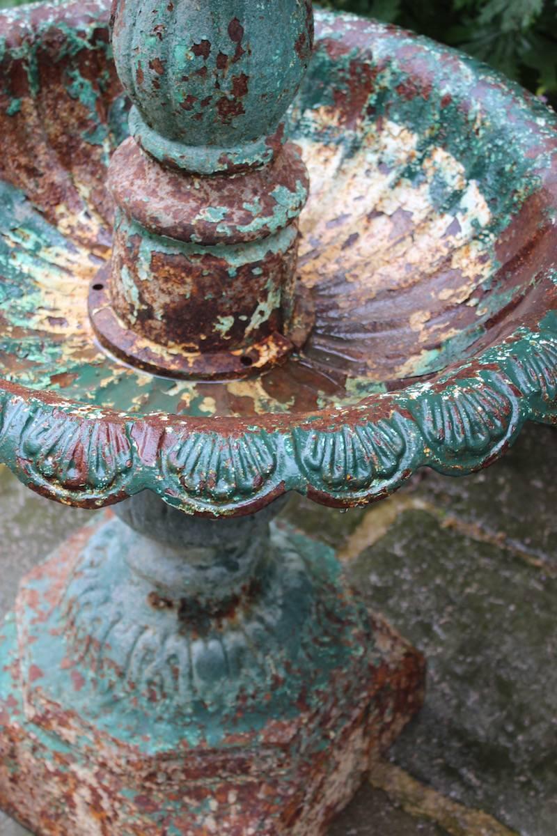 A wonderfully antiquated looking cast-iron garden fountain or bird bath, with remnants of original and historic painted surfaces, English, mid-19th century.