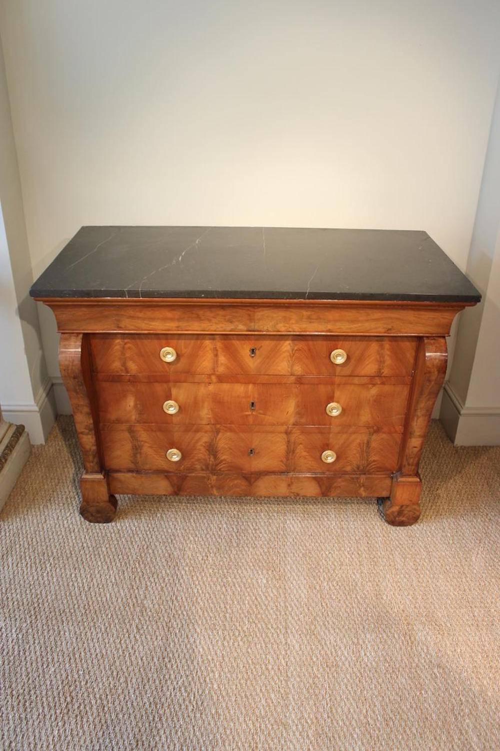 A large and well-proportioned, figured walnut commode with a marble top above a blind frieze drawer and three further drawers with book-matched veneers, French Restoration period, circa 1840.