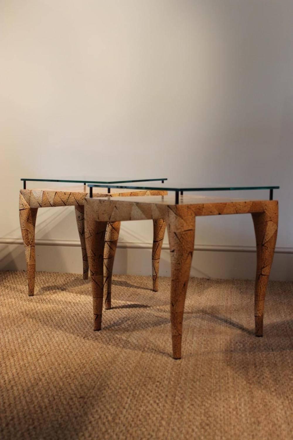 An unusual and highly decorative pair of late 20th century coconut-veneered occasional tables with raised glass tops by R & Y Augousti, London (applied maker's label).