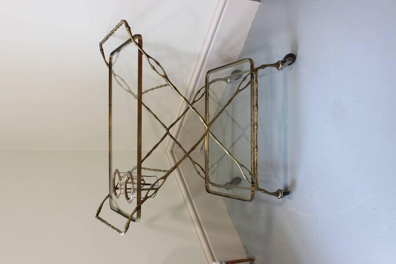 A very unusual and of great design, mid-20th century naturaslistically styled bamboo drinks trolley in brass and glass, that will make a statement in most settings. Practical and stylish.
  