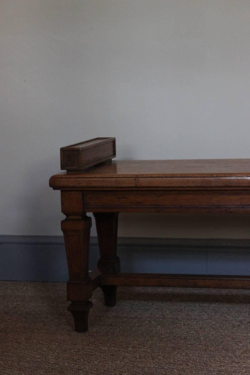 A good solid oak hall bench with six panelled tapering legs, with provenance to the Bank of France, circa 1920s.
 