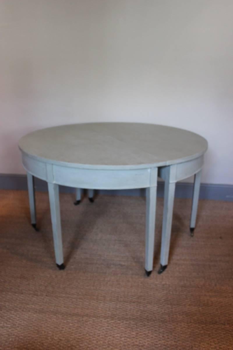 A highly decorative pair of Georgian demilune side or console tables with a later painted finish and original castors, English, late 18th century.
 