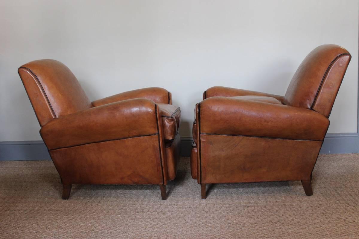 A good pair of 1940s French leather club chairs with original leather and later cushions.
 