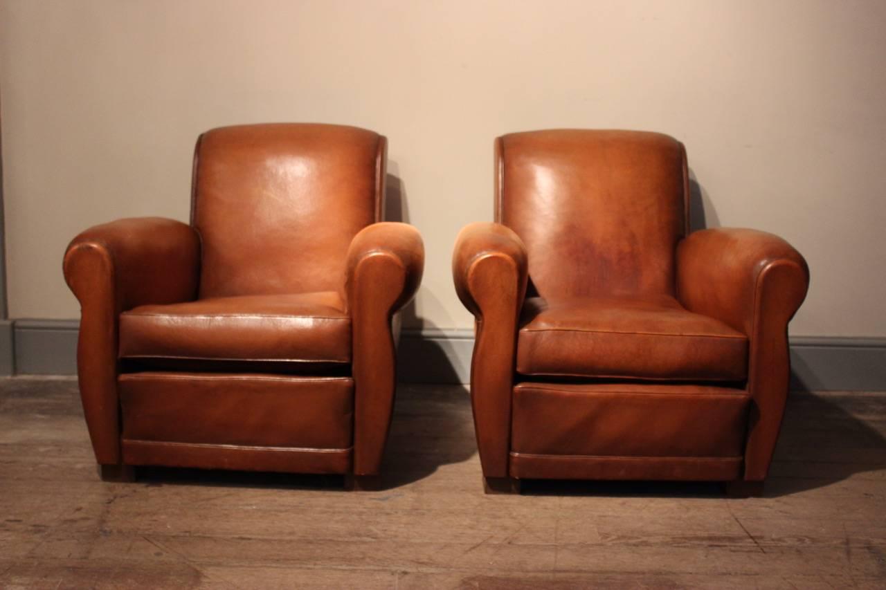 A good and comfortable pair of leather club chairs in original tan leather, French, circa 1950s.