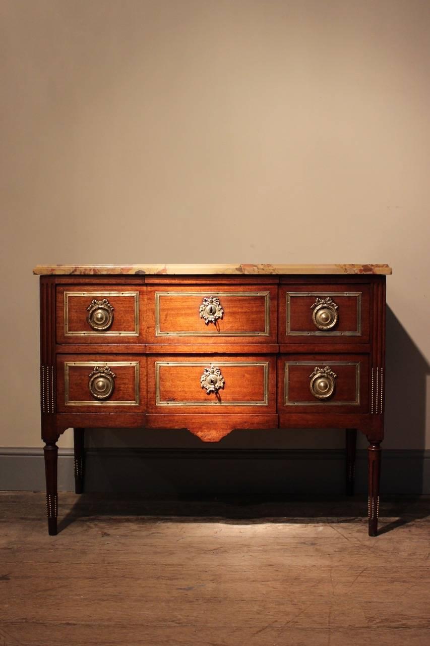 A fine quality late 18th century Italian bronze-mounted mahogany commode, with a moulded rectangular marble top, of good color and proportions, circa 1780.