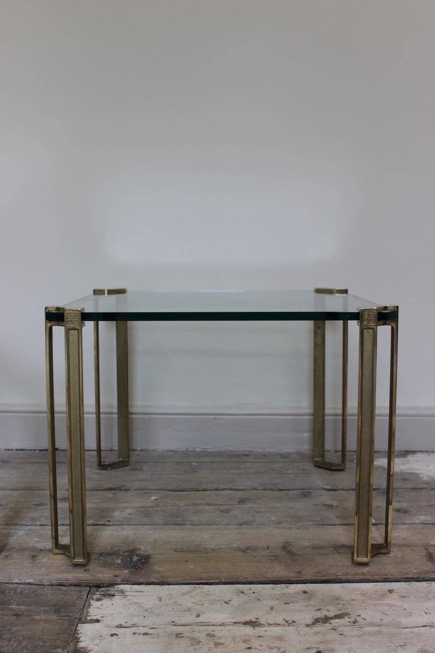 A smart pair of cast brass and glass occasional or sofa tables with canted square tops, circa 1970-1980 by Peter Ghyczy.