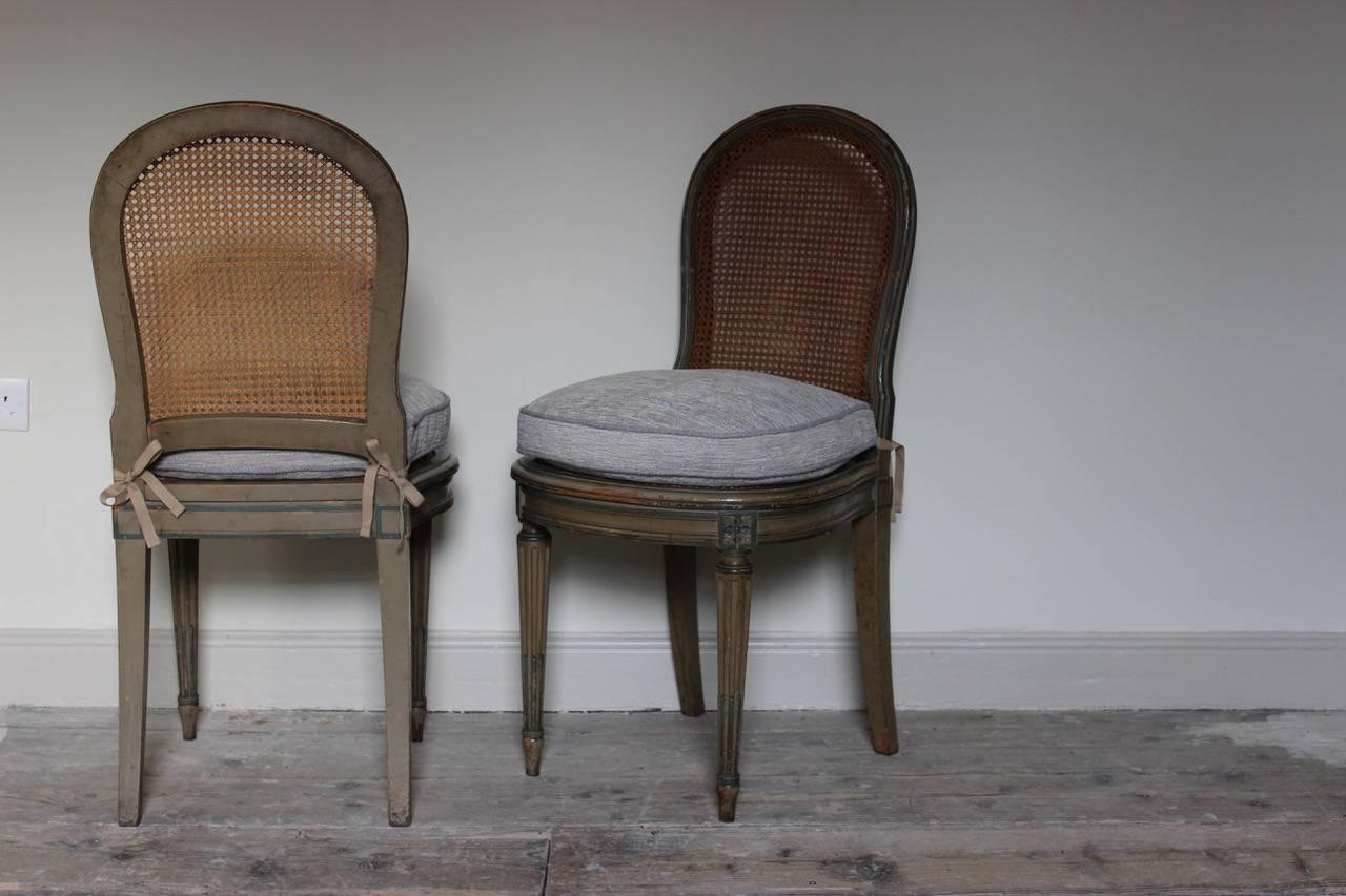 A good set of circa 1920s-1930s French painted dining chairs in the Louis XVI taste, retaining the original paint and caning, with new seat cushions, that will work well in most settings.

Measures: 46cm high (floor to seat without cushion) x 54cm