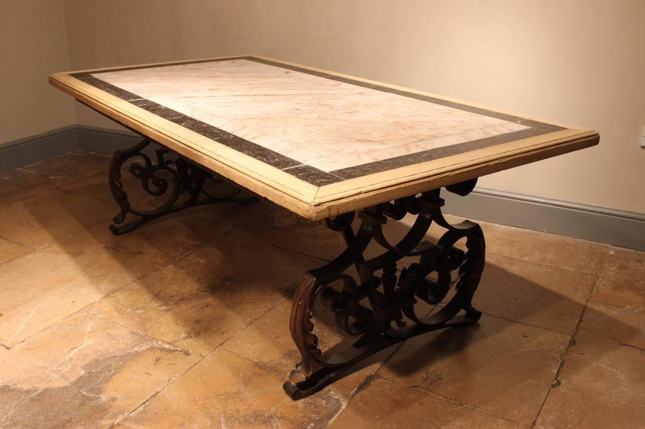 A decorative circa 1900 French wrought-metal table with an oak-framed marble top. This elegant and robust table will make an ideal dining table for eight or library / centre table, France, circa 1900.
 