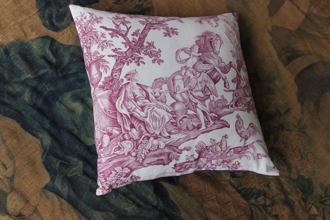 A 19th century French Toile de Jouy “Four Continents” cushion, with 18th century purple linen backing.
 