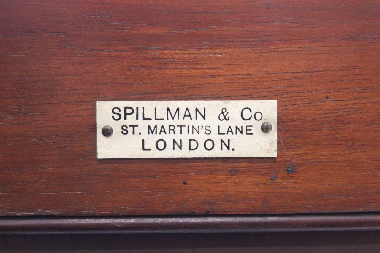 A good quality late 19th or early 20th century ebonised bookcase in the Georgian style, the glazed upper-section enclosing four adjustable shelves, retaining its original retailer's label for Spillman & Co, St. Martin's Lane, London	
