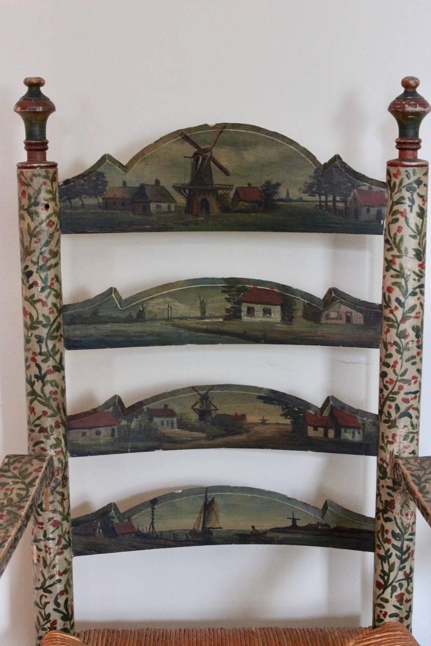 An unusual and decorative pair of late 19th century polychrome-painted ladderback armchairs with rush seats, the backs painted with various canal, river-bank and harbour scenes. 

Measures: Seat height 48 cm.