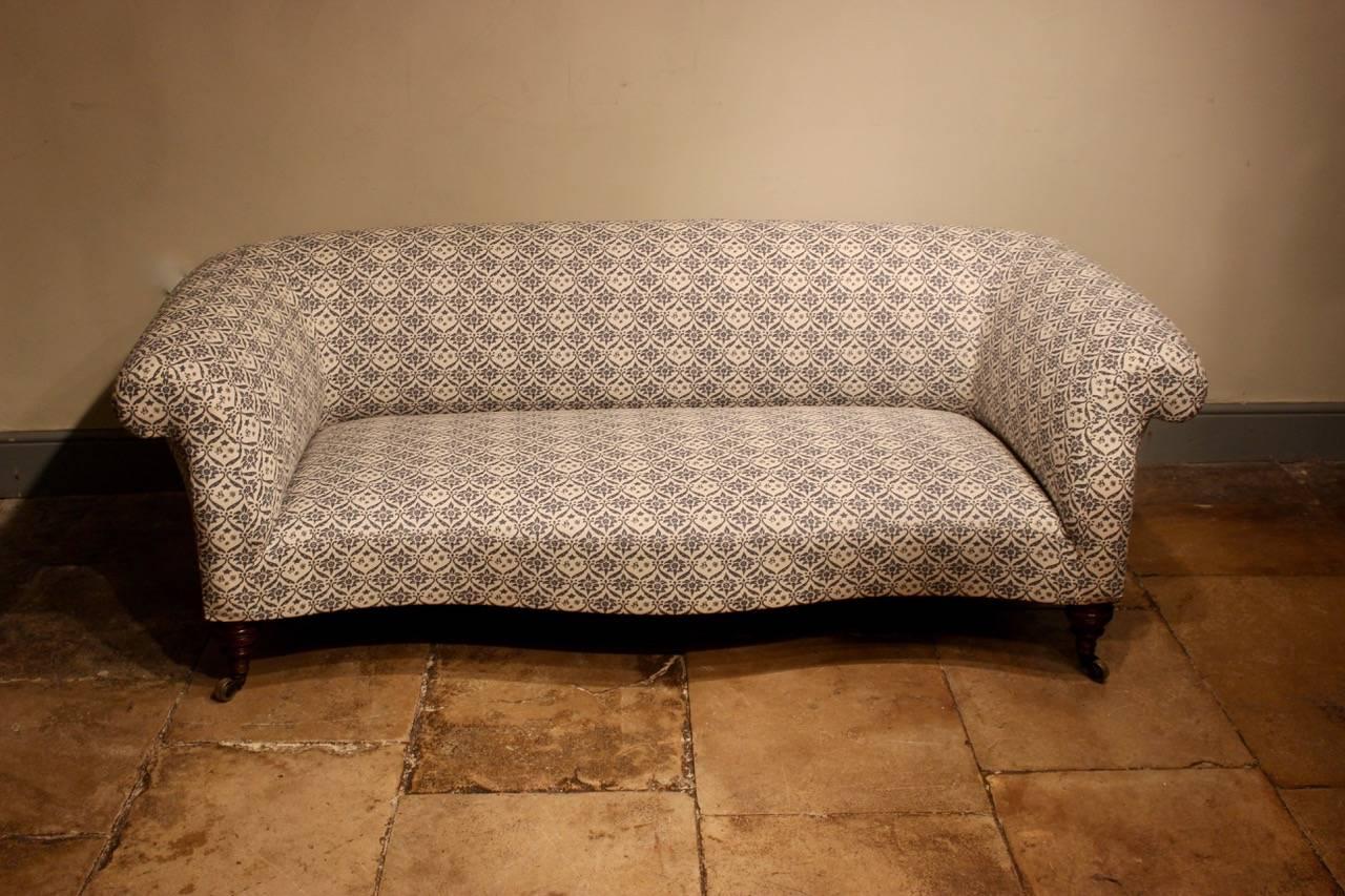 An elegant, fine quality, and of rare serpentine form, late 19th century chesterfield sofa by Howard & Sons, re-covered in traditional monogrammed fabric. 

Measures: Seat height 38cm.
 