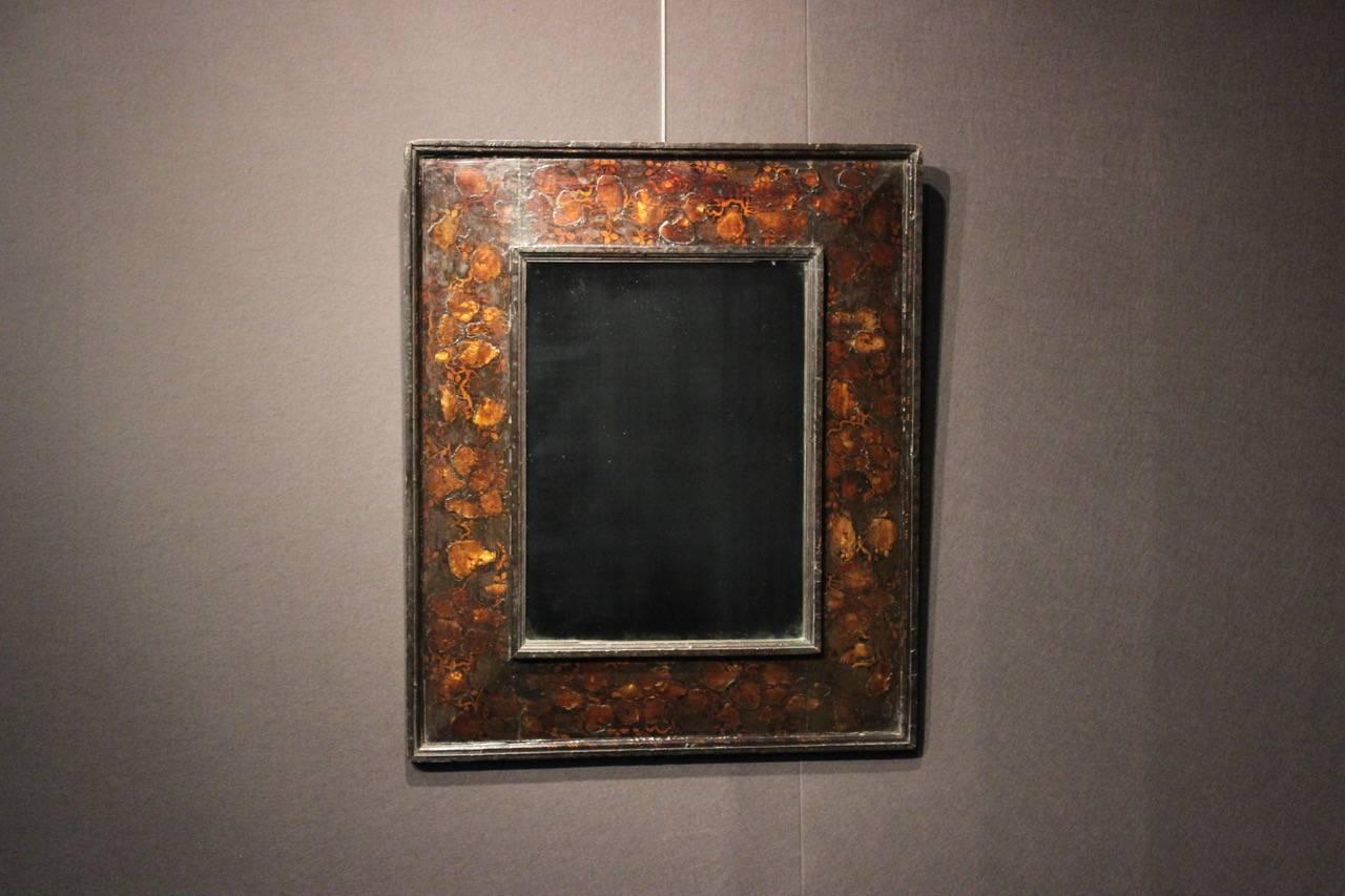 An unusual and decorative early 18th century Dutch japanned and mother-of pearl inlaid rectangular mirror that would work well in a contemporary setting.
 