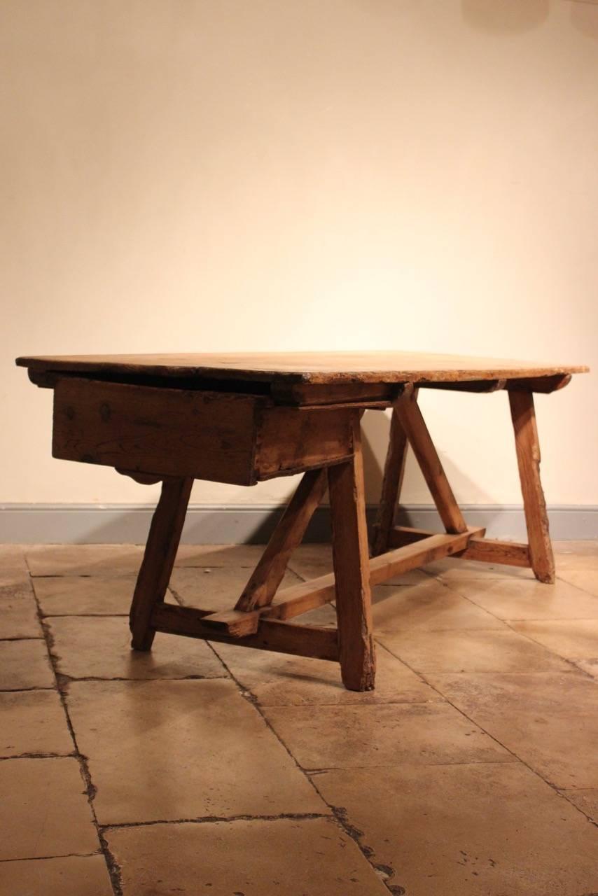 A rare, and in untouched original condition, 18th century Spanish pine farmhouse table with a three-plank top and a deep drawer to one end, that would work equally well as a kitchen table or as a large side table	
.