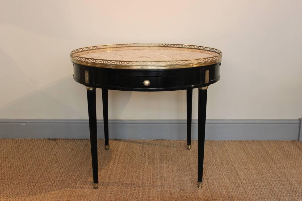 A fine quality, early 19th century French ebonised gueridon, retaining the original brass nouns and marble , with a single drawer and two brushing slides. 

France Circa 1820