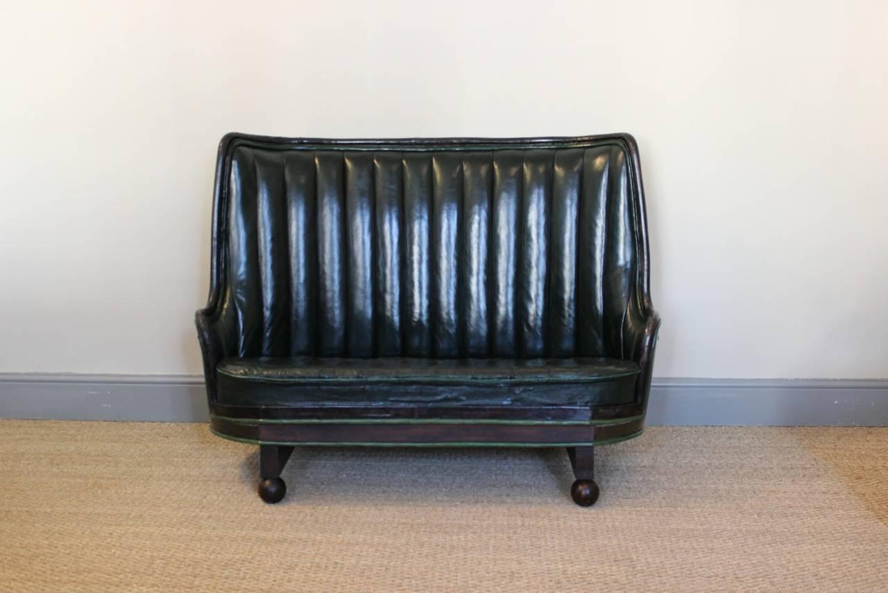 A very unusual and with a great colour, circa 1930s Spanish Sofa, having been converted from wine barrels, with its original green leather upholstery (the back replaced in hand dyed leather to match the existing one).